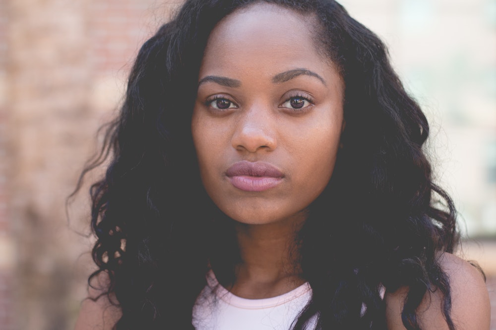 woman with long hair staring at the camera