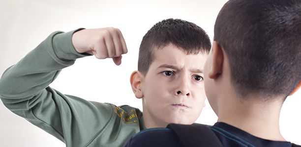 one boy punching another boy