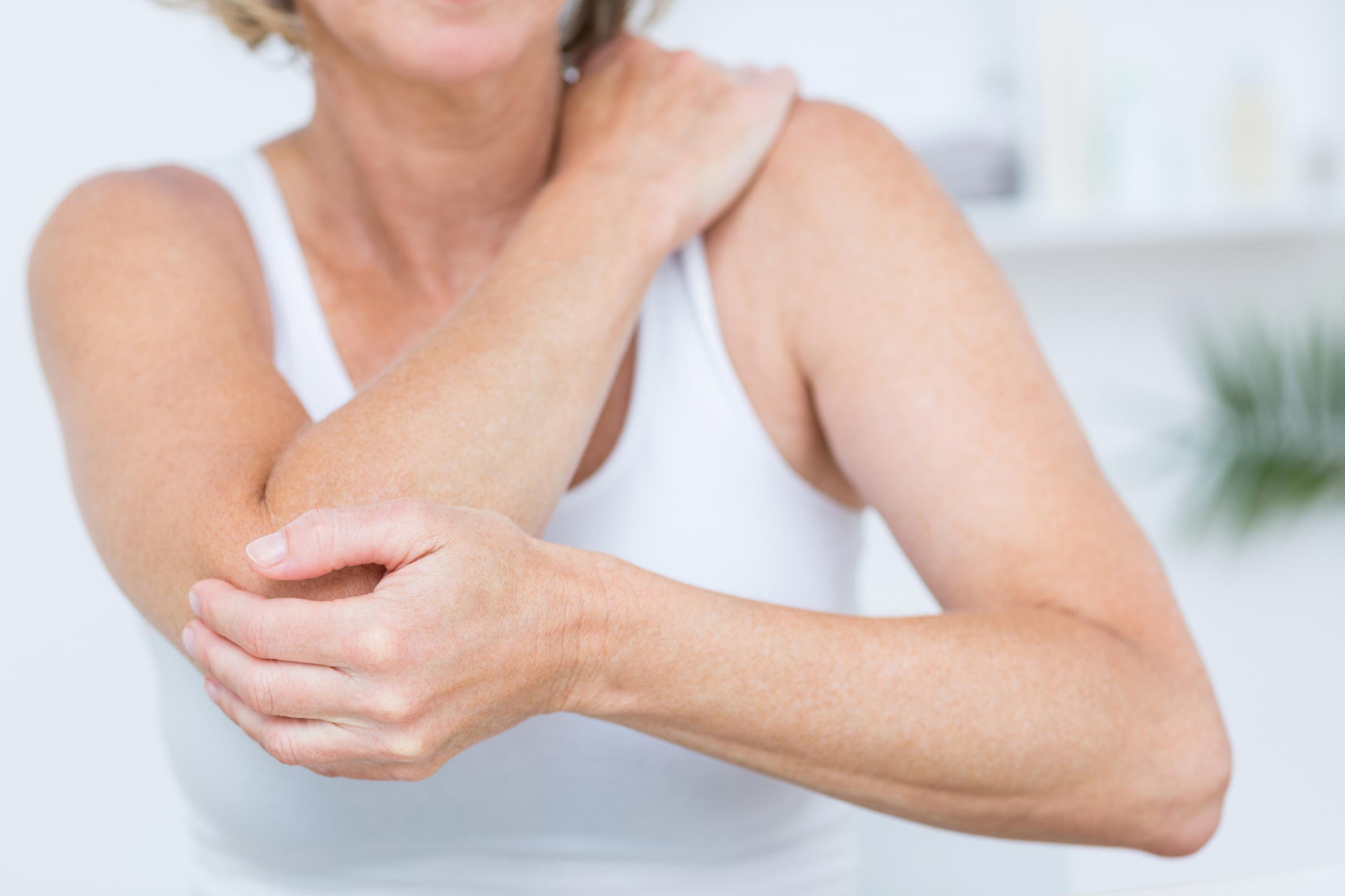 Torso of a person grabbing their arm