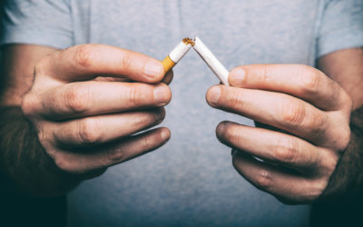 man breaking a cigarette in half